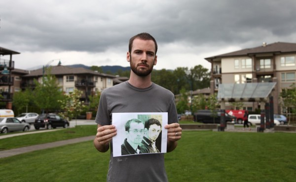 Ian MacKenzie holding a picture of Shane and Josh.