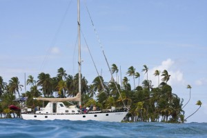 A sailboat anchored in sheltered water and surrounded by uninhabited palm-ringed islands is the Caribbean dream..