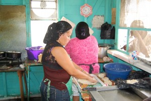 Belizian women working hard in the kitchen.