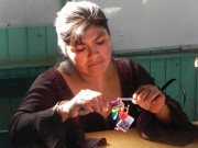 A woman working in the SKIP artisan collective, making a piece of jewelry to sell to supplement her family’s income. SKIP provides training workshops to mothers to teach them how to make handicrafts, which are then sold on SKIP’s website and in shops around Trujillo that cater to tourists. Paola attends many of these workshops and sells her bracelets for 10 soles each.