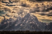 Upon completing the first 1000 miles and 18 days of my journey across America by bicycle, I entered Grand Teton National Park. It was the end of the day. The clouds were gathering and the sun was ready to call it a day, as was I. I stopped along the side of the road, got off my saddle and waddled to a quiet spot near a meadow and took in the scene as you see it here. Peace at the end of a long and glorious day.