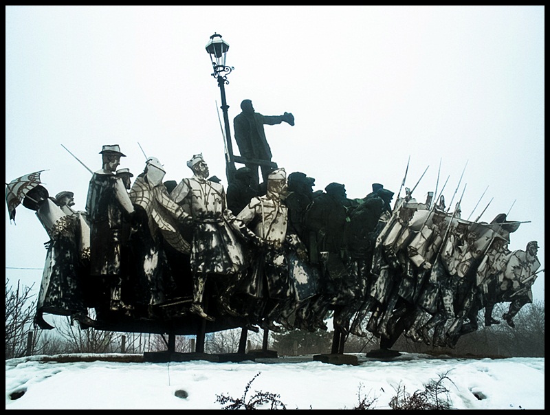 A mishmash of tin-looking soldiers, officials and workers makes up the Bela Kun Memorial Bela Kun was the leader of the 1919 Hungarian Soviet Republic and is showing the way with his hat at the back of this memorial.