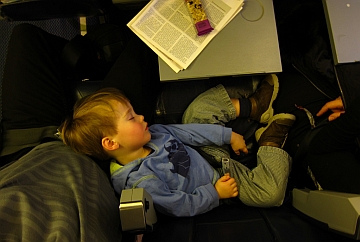 child sleeping on an airplane