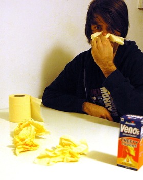 Guy blowing his nose