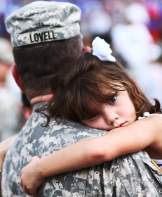 a little lady hugging a soldier portrait