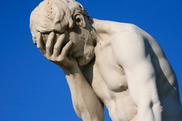 statue with head in hands