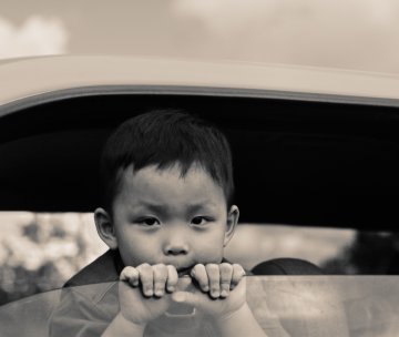 Asian child in car