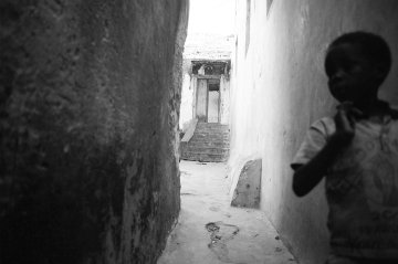 Boy running in alley, Kenya