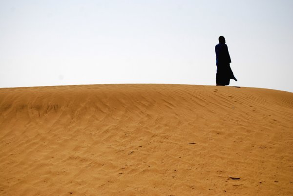 Nomad on a sand dune, Morocco