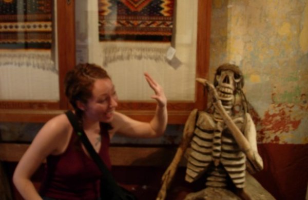 High fiving a Mexican skeleton