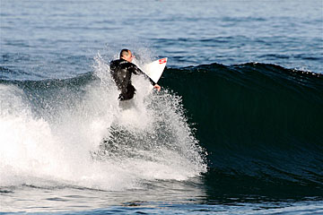 Spanish surfer emerging from a tube
