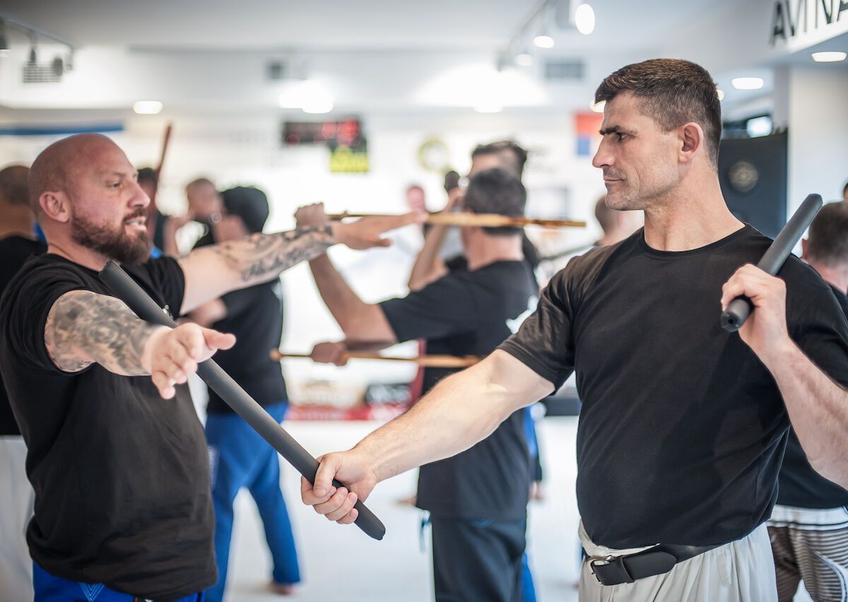 two men sparring with Filipino stick fighting martial arts Stock Photo