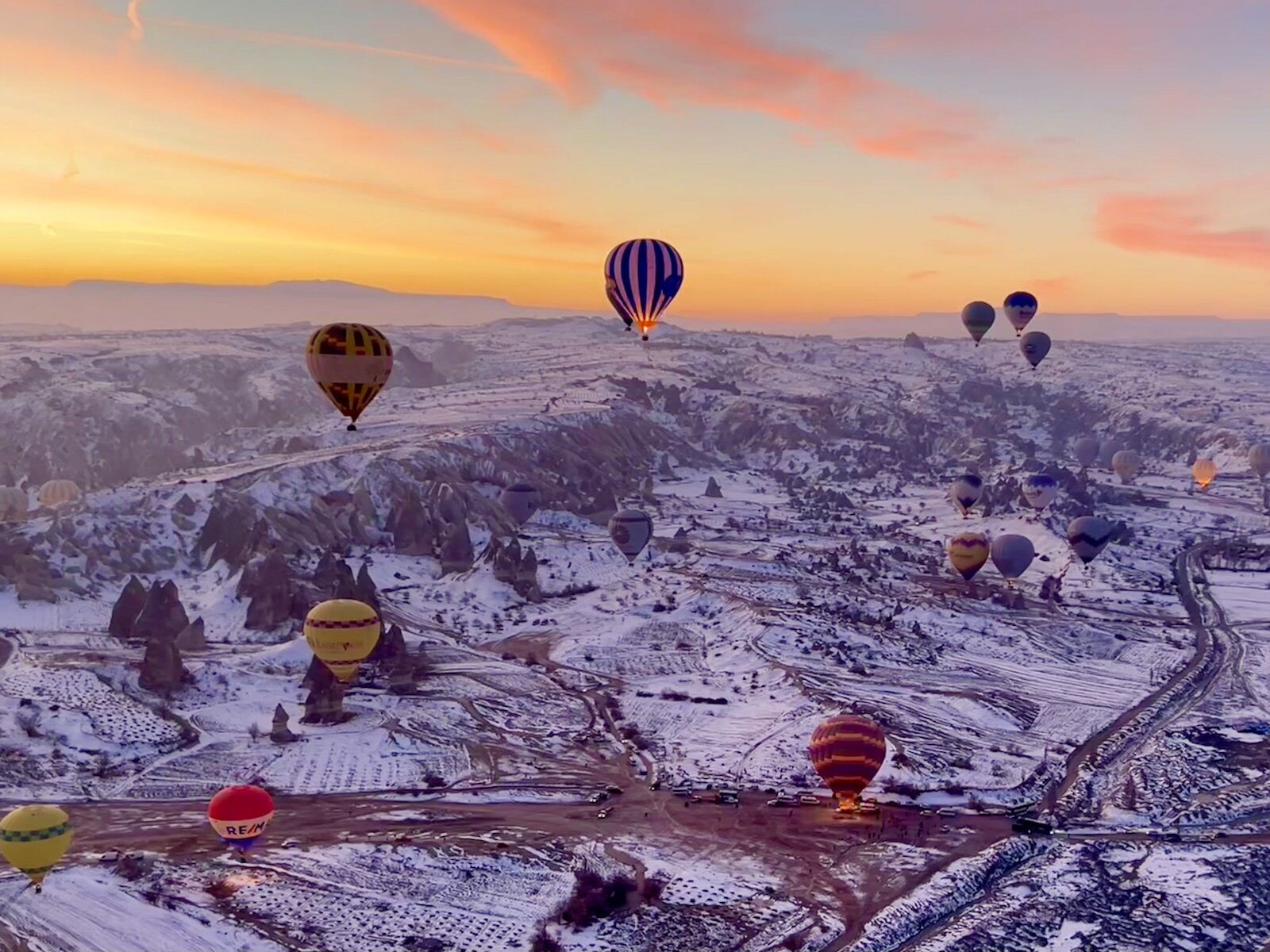 Cappadocia hot air balloons over a snow-covered landscape