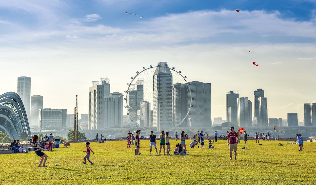 Group of people stand in front of Marina Barrage in Singapore