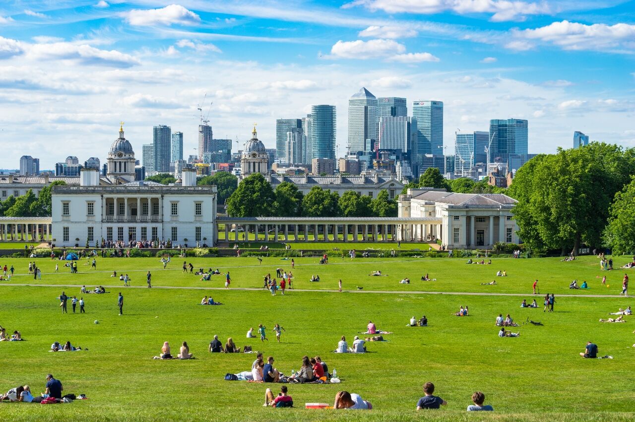 People in a park with London skyline in the background