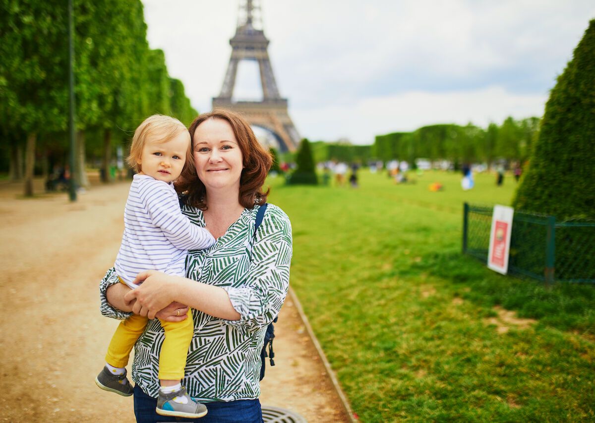 Mother And Son Near Eiffel Tower In Paris France 1200x853 