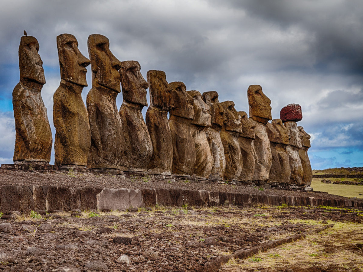  Large stone statues called Moai stand on a rocky platform on Easter Island, a remote island in the southeastern Pacific Ocean.