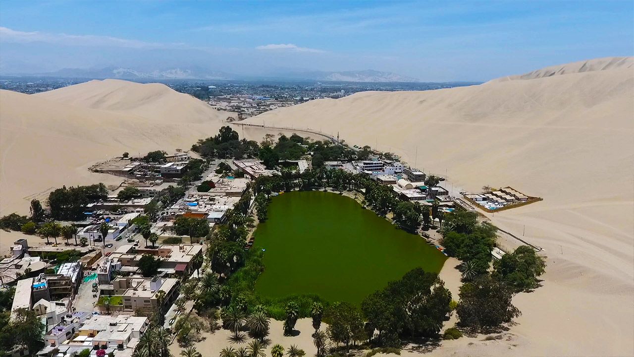 How To Visit Huacachina: Peru's Desert Oasis Amidst Sand Dunes