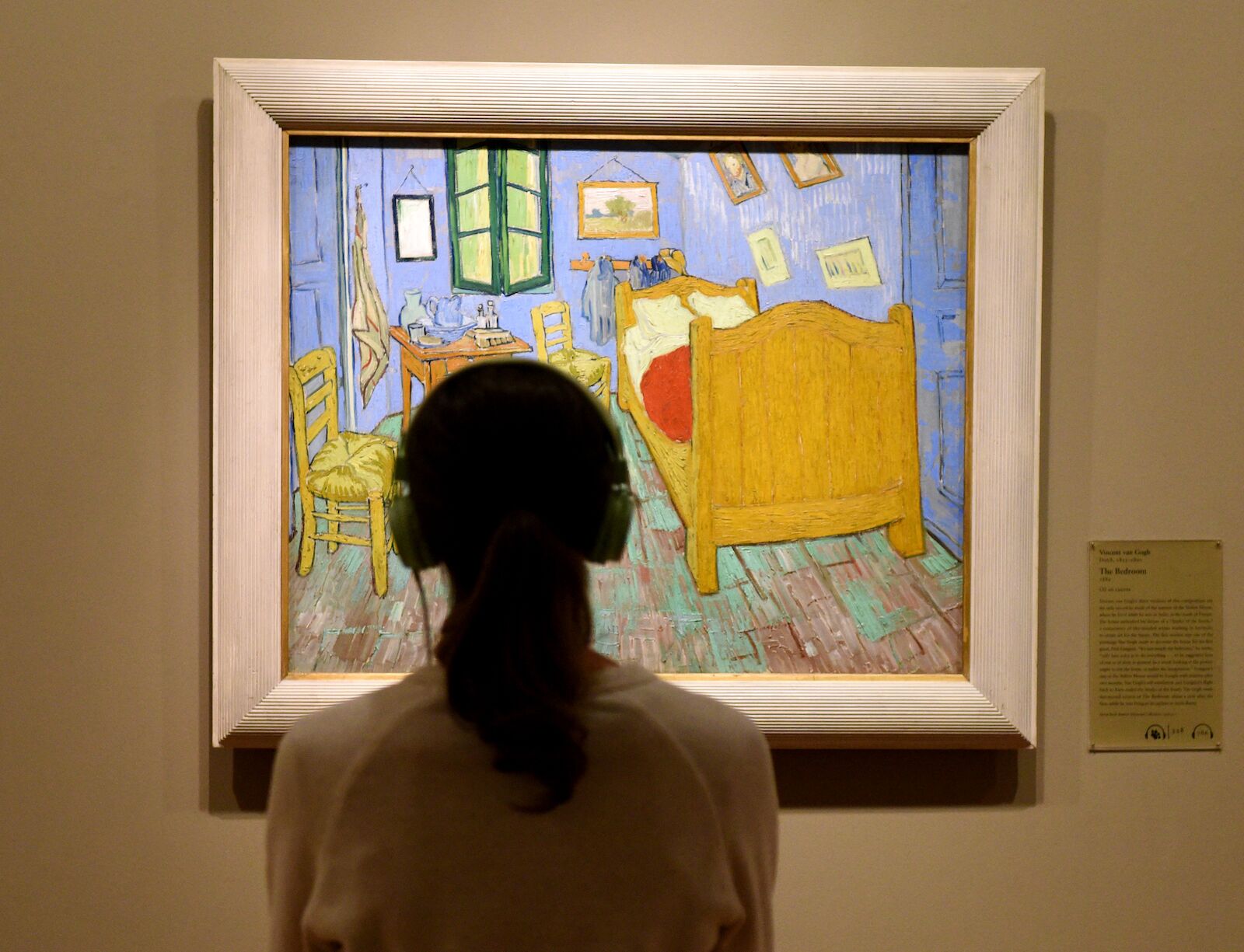 person admiring Van Gogh's "The Bedroom" at the Art Institute of Chicago