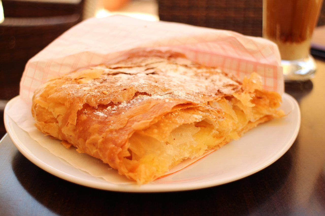 Bougatsa, Greek pastry with fillings on a table in a restaurant