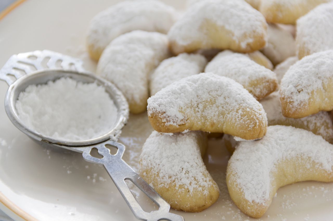 Kourabiedes, crescent shaped cookies, dusted with powdered sugar