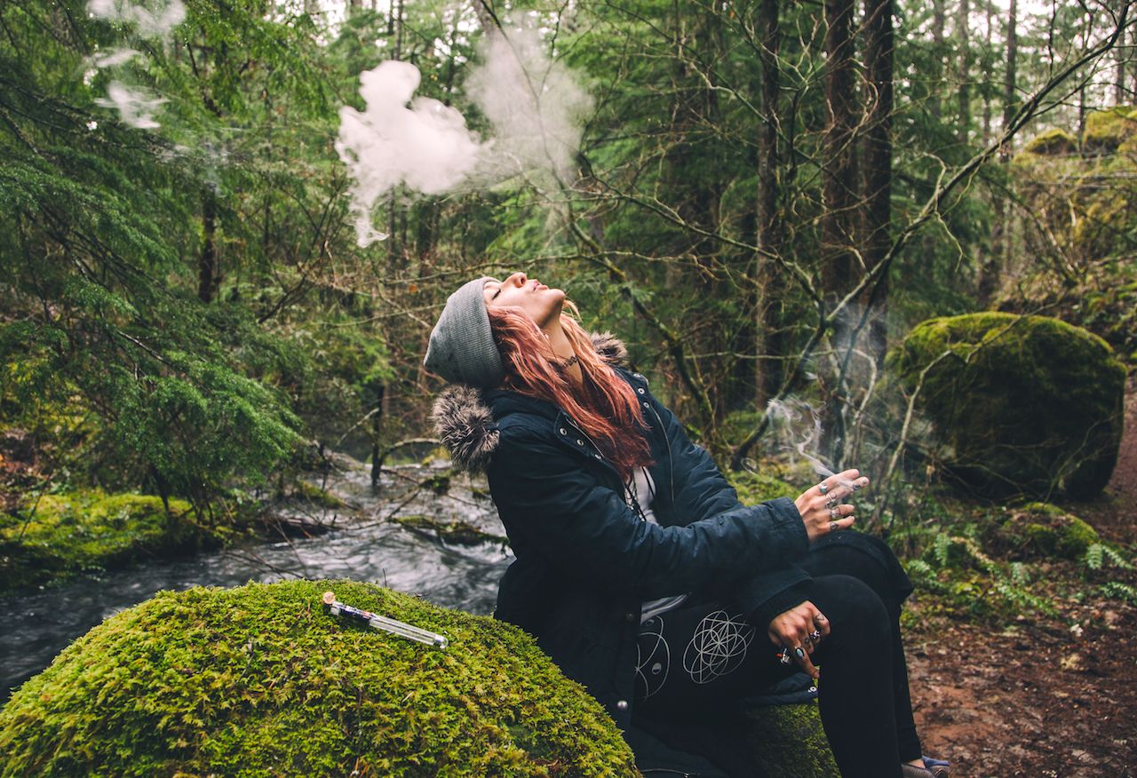 Woman smoking weed in woods