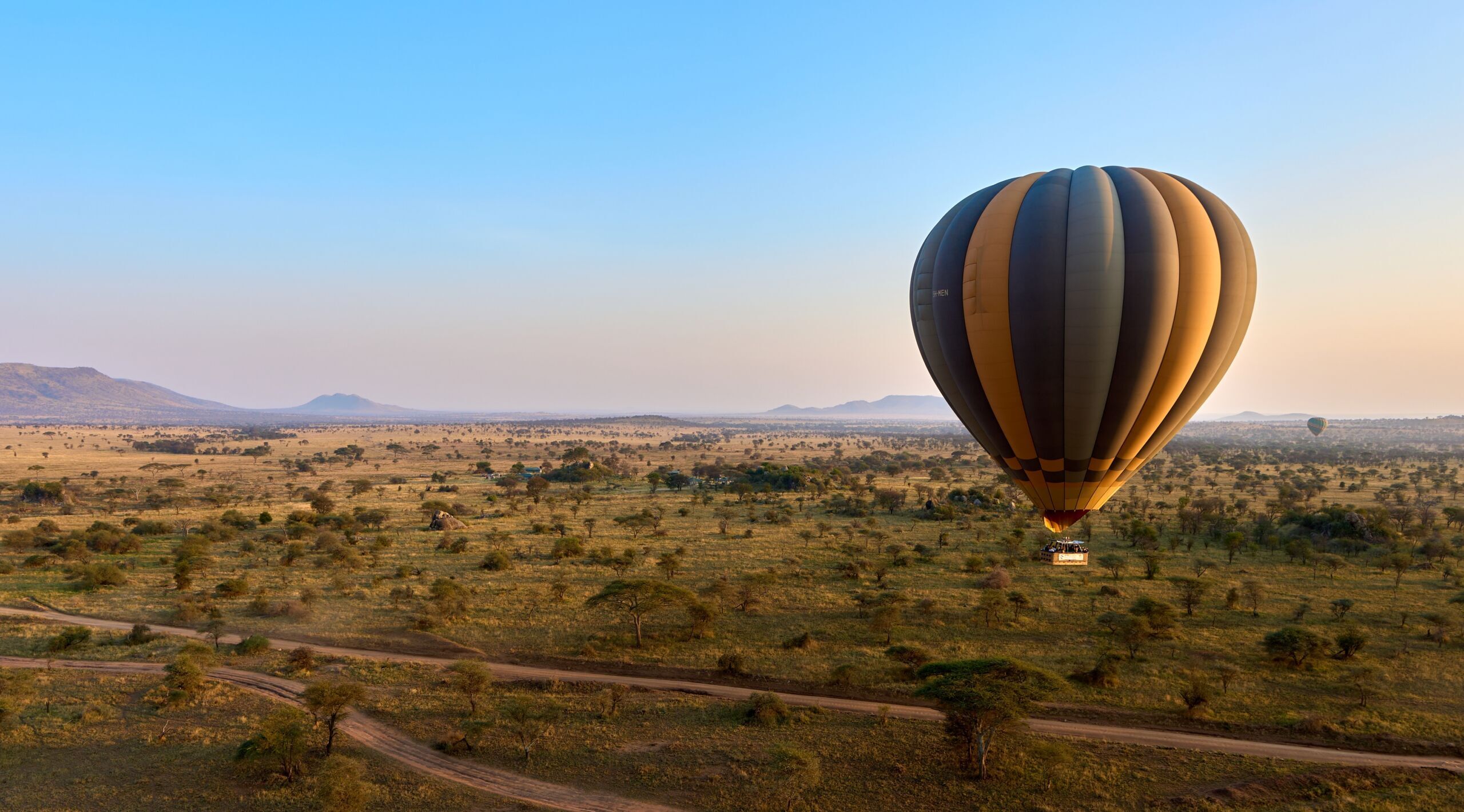 Hot air balloon floating over the morning savanna in the Serengeti – Aerial Adventure in Tanzania