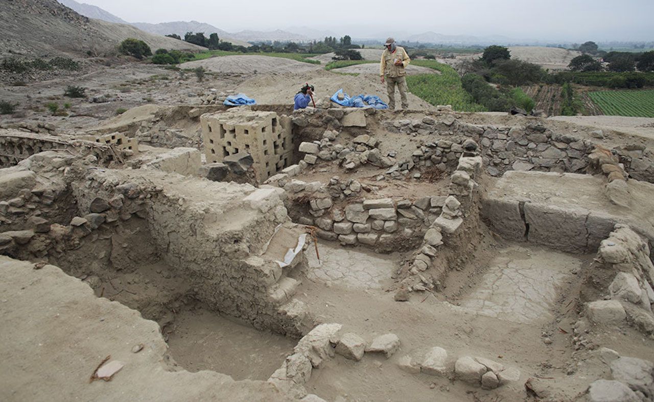 Two people participating in an archeological dig in Peru