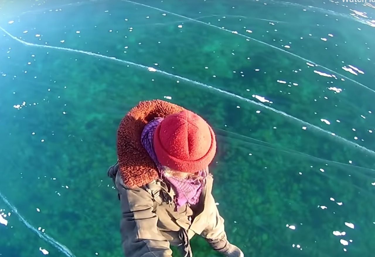 Man Walks Across Frozen Lake Baikal In Siberia