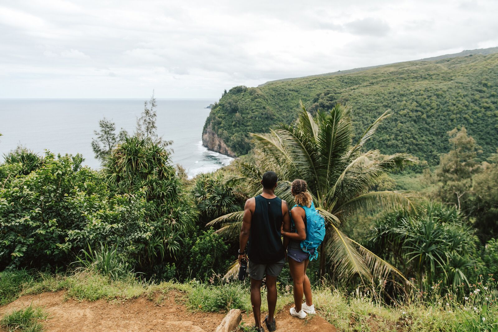 A couple looking at the view on a Hawaii hiking trail on the big island
