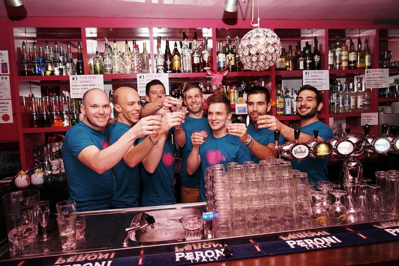 Bartenders raise a glass behind gay Amsterdam bar PRIK