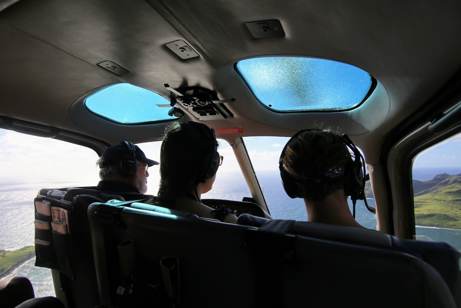 people on a helicopter tour above kauai and niihau forbidden island