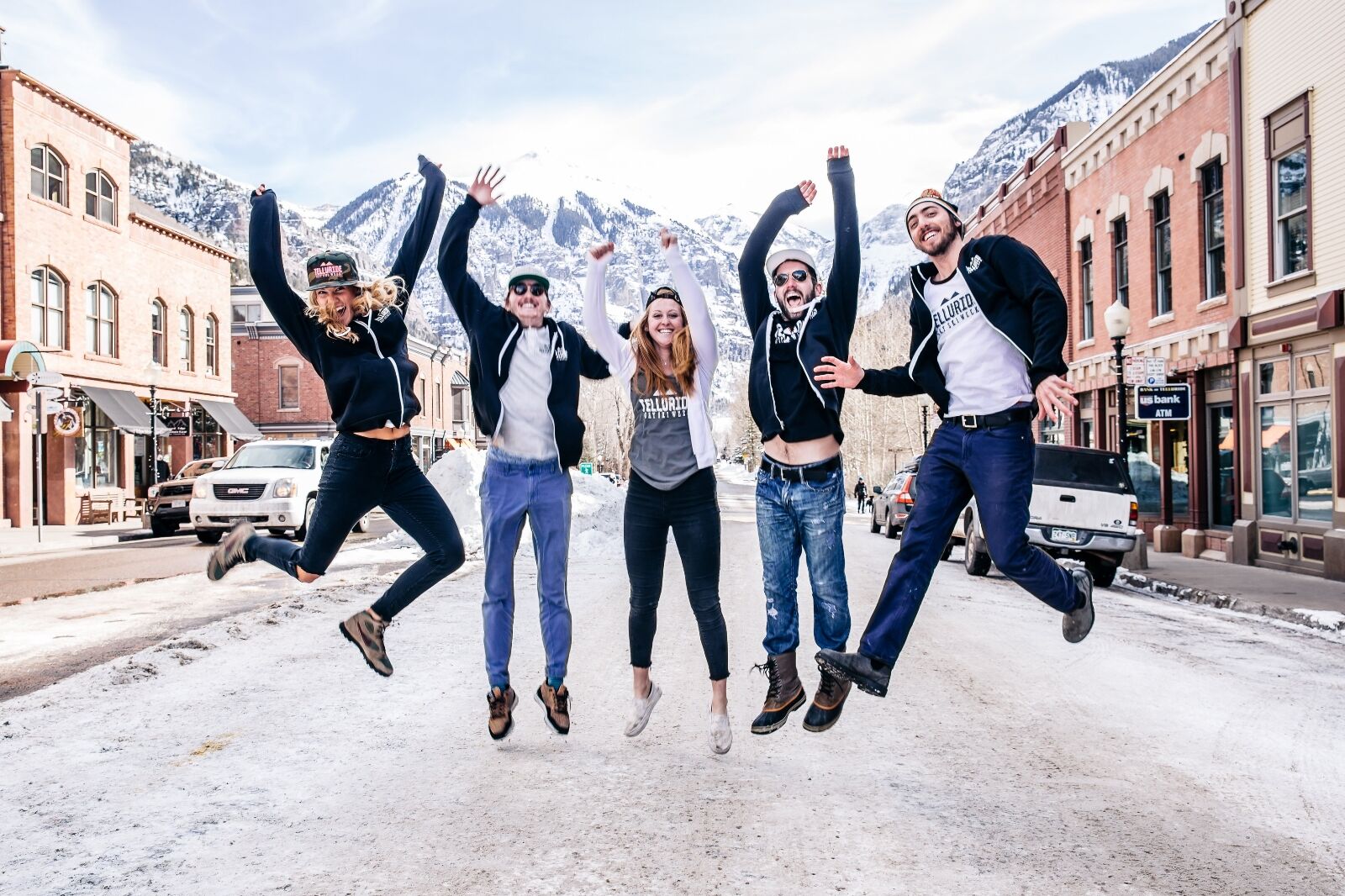People jumping in the air at Telluride gay ski week