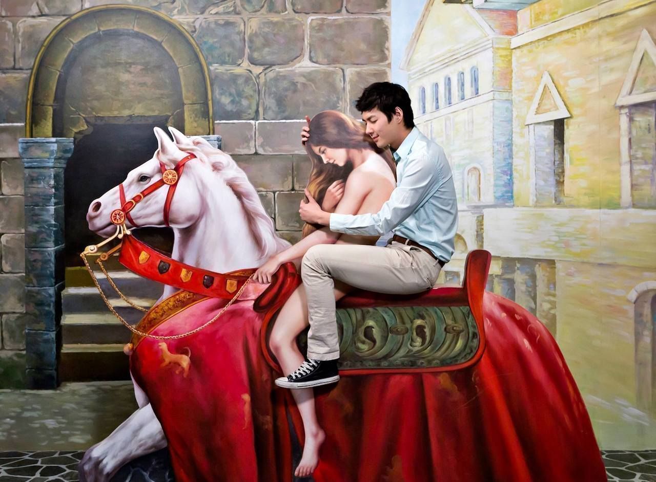Man hugging a replica of naked Lady Godiva riding a horse at the Love Museum in South Korea.