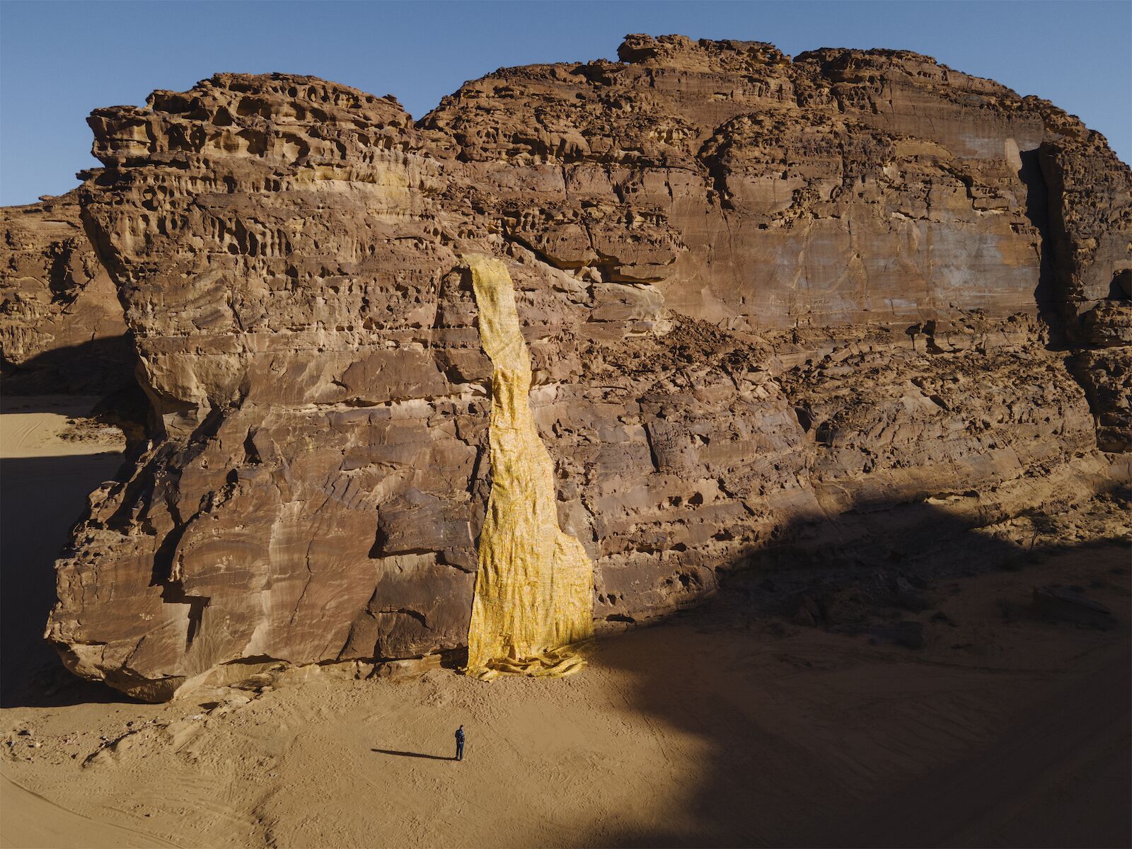 Artwork of an illusory gold waterfall in the Saudi Arabian desert for Desert X 2022.