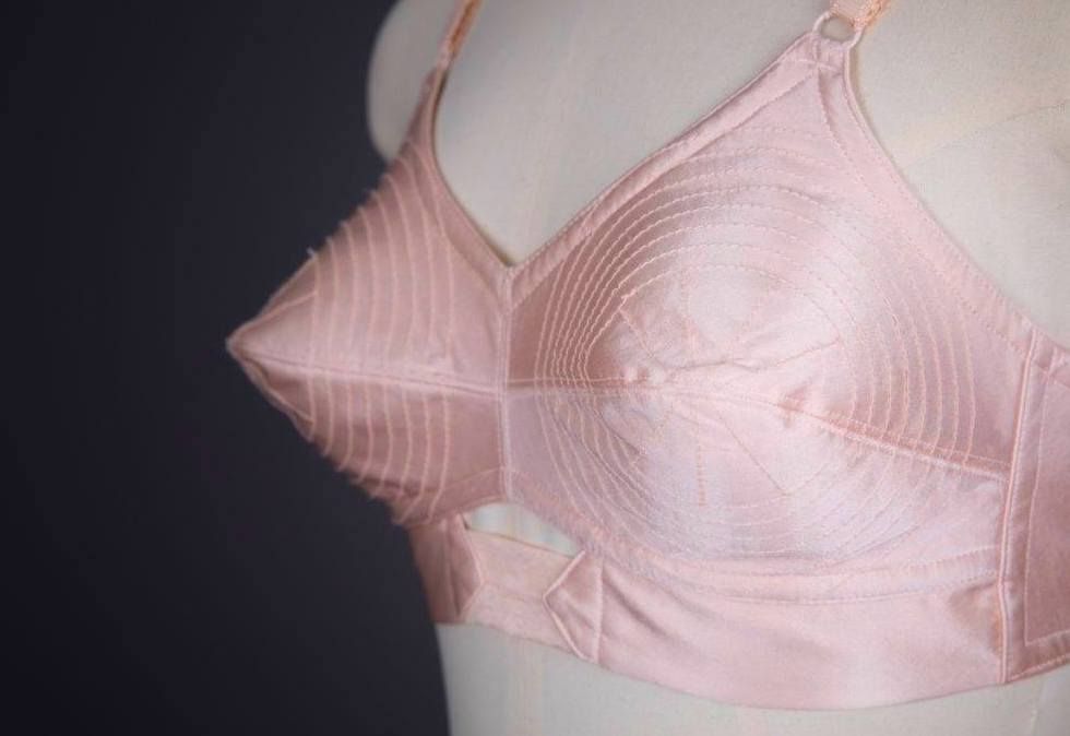 Pink silk bra with pointy cup displayed at the he Underpinnings Museum