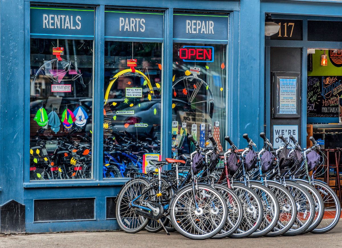 A Bike Shop Store Front With Multiple Bikes Lined Up On The Sidewalk In Downtown Portland Oregon 1200x869 