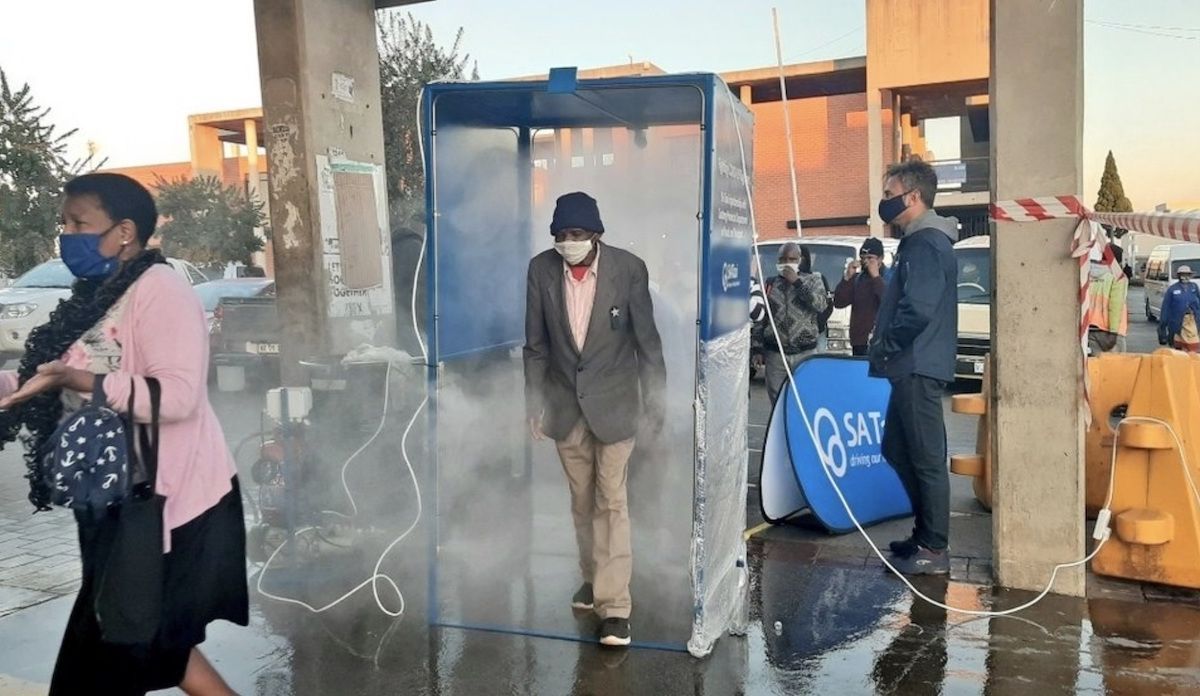 Sanitation Booth Sprays Commuters in Soweto, South Africa