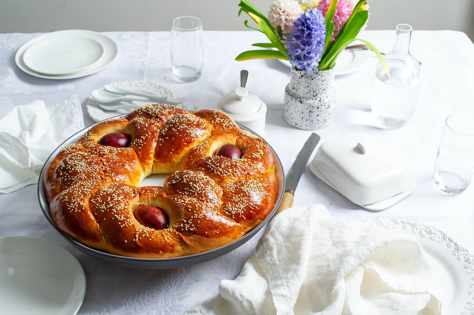 Greek Easter bread called tsoureki with red dyed hard boiled eggs