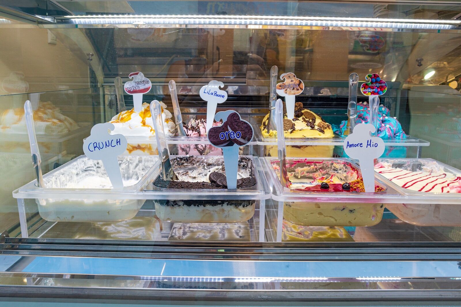 different flavors of Greek ice cream in a shop display window