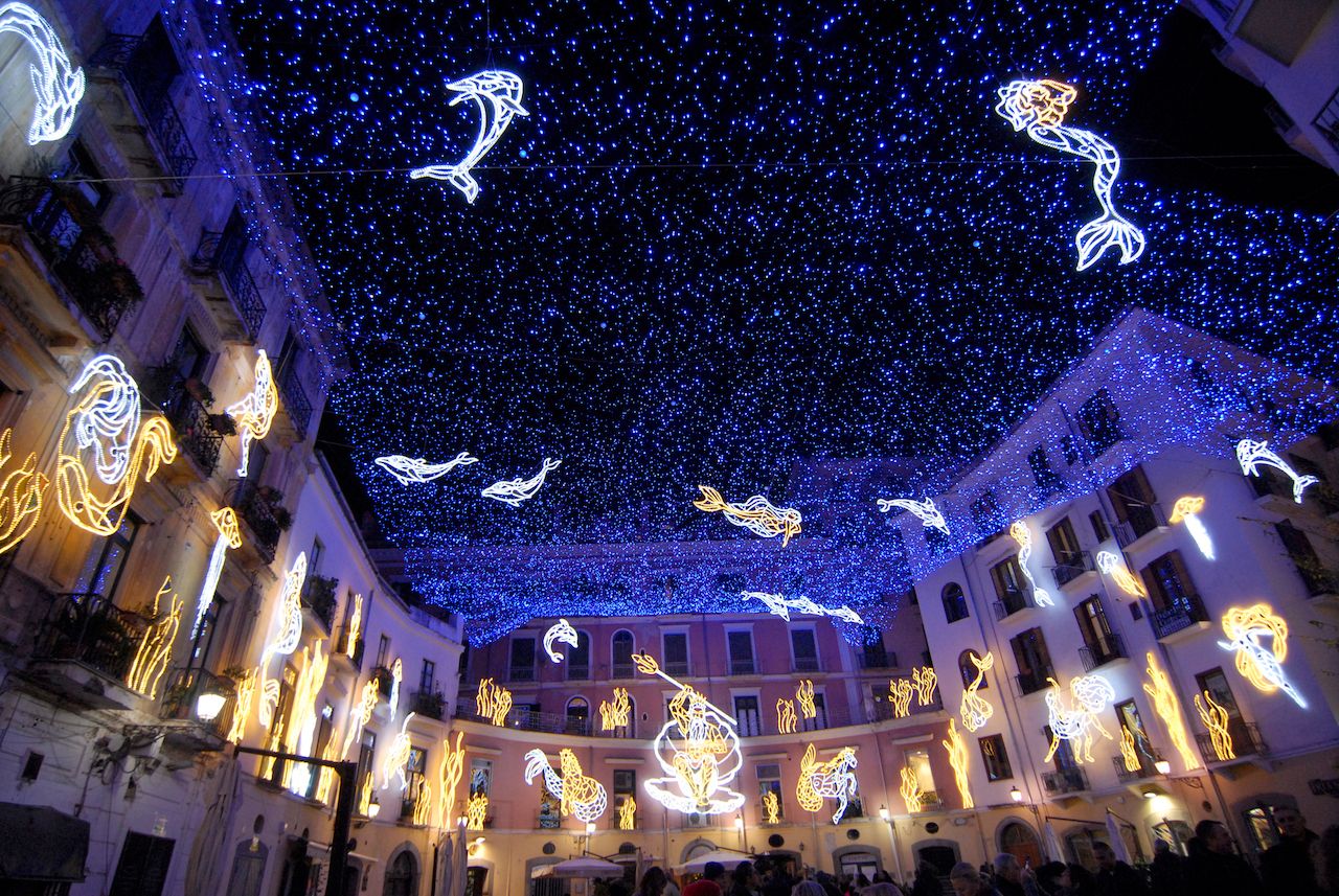 Christmas lights cover the sky above a street in Salerno, Italy