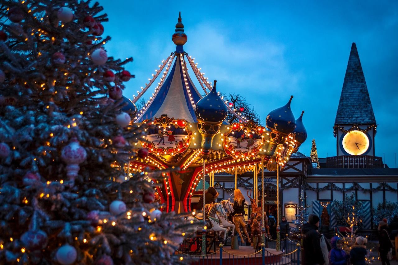 A carousel and holiday lights display at Tivoli