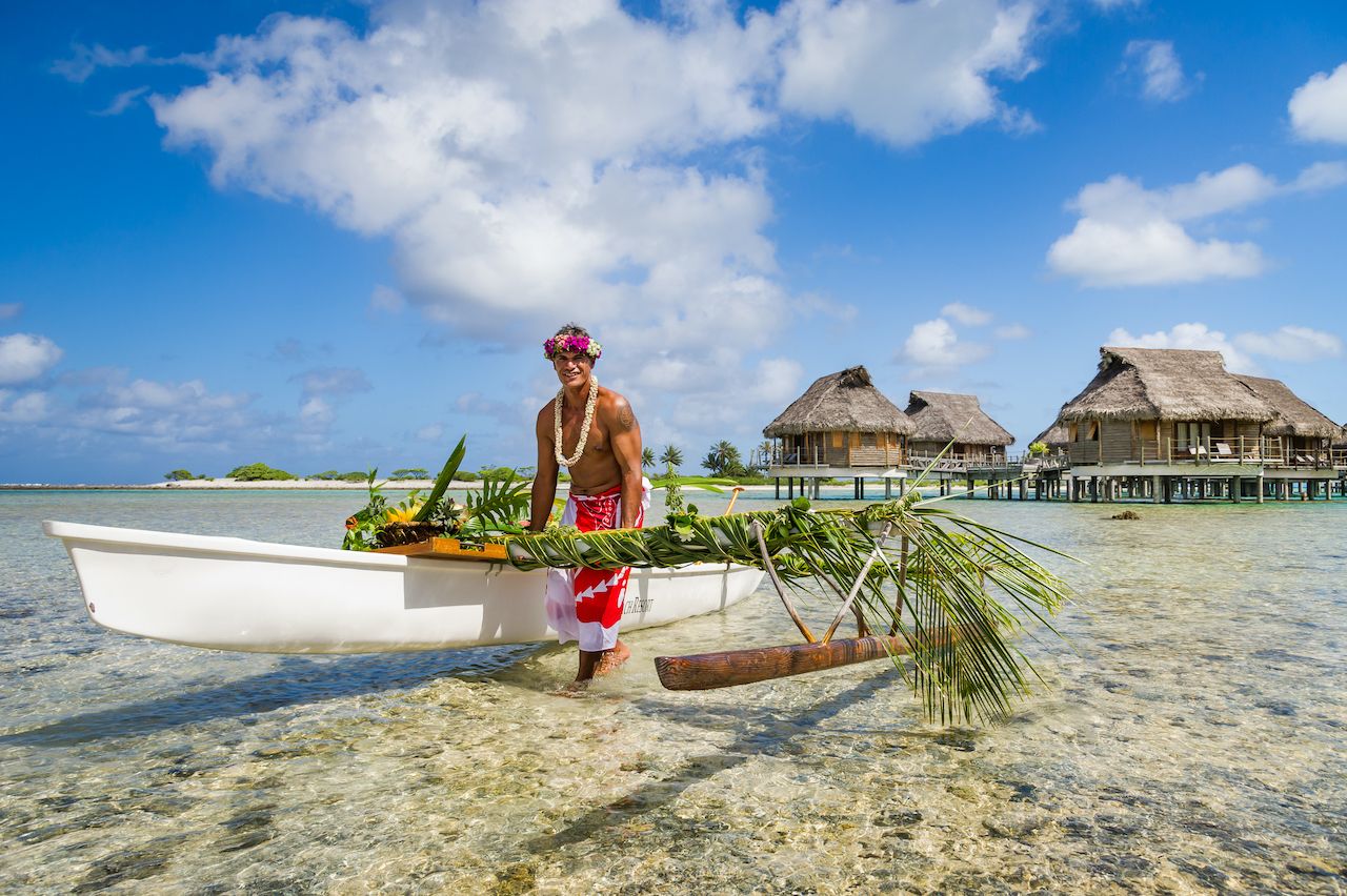 Tahitian with a boat in the water