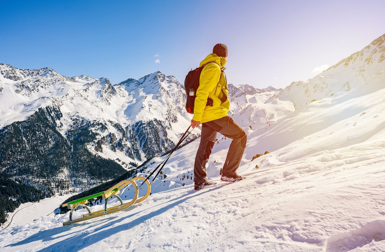 Person carrying sled