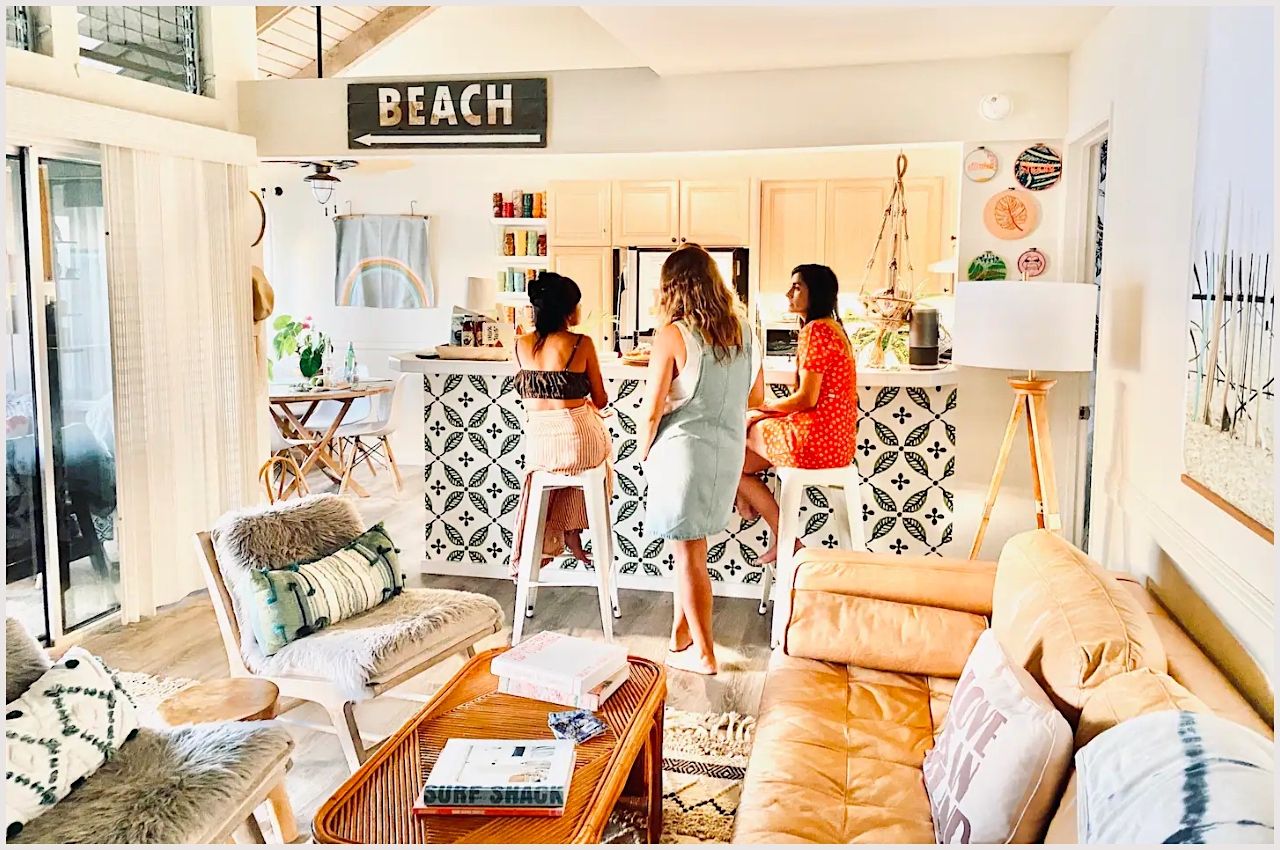 Kitchen with guests at surf shack Airbnb rental in Kauai