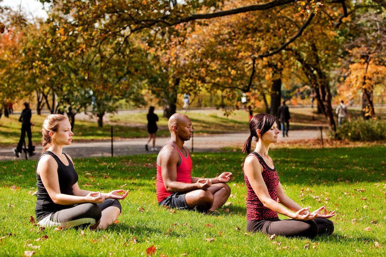 A,Group,Of,People,Relaxing,With,Meditation,In,A,City
