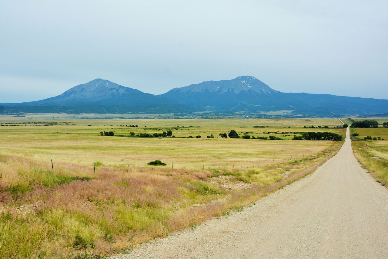 Long empty dirt road headed towards the Spanish Peaks in Southern Colorado., Spanish Peaks