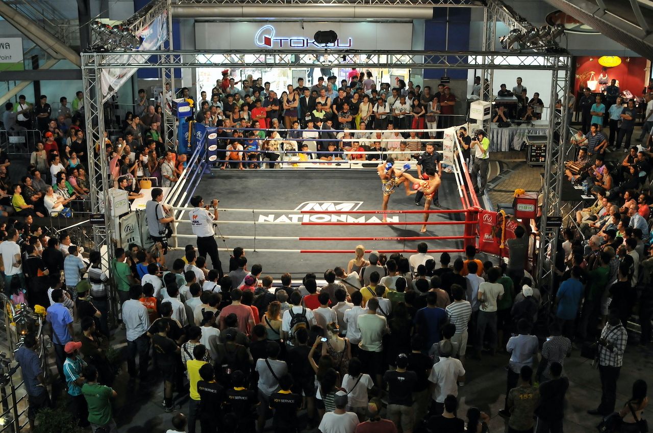 BANGKOK - NOV 7: Unidentified Muay Thai fighters compete in an amateur Thai kickboxing match as spectators watch on at MBK Fight Night on Nov 7, 2012 in Bangkok, Thailand., bangkok art and culture