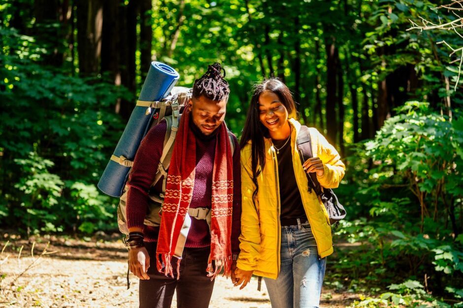 couple hiking in woods - man and black woman hiking