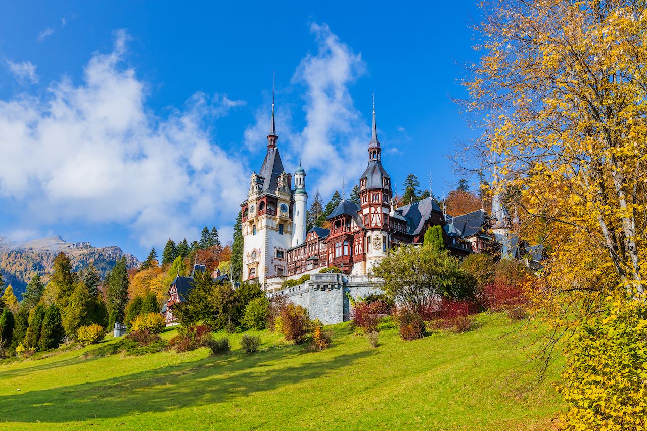 gay friendly places eastern europe Peles castle in autumn. Sinaia, Prahova county, Romania.